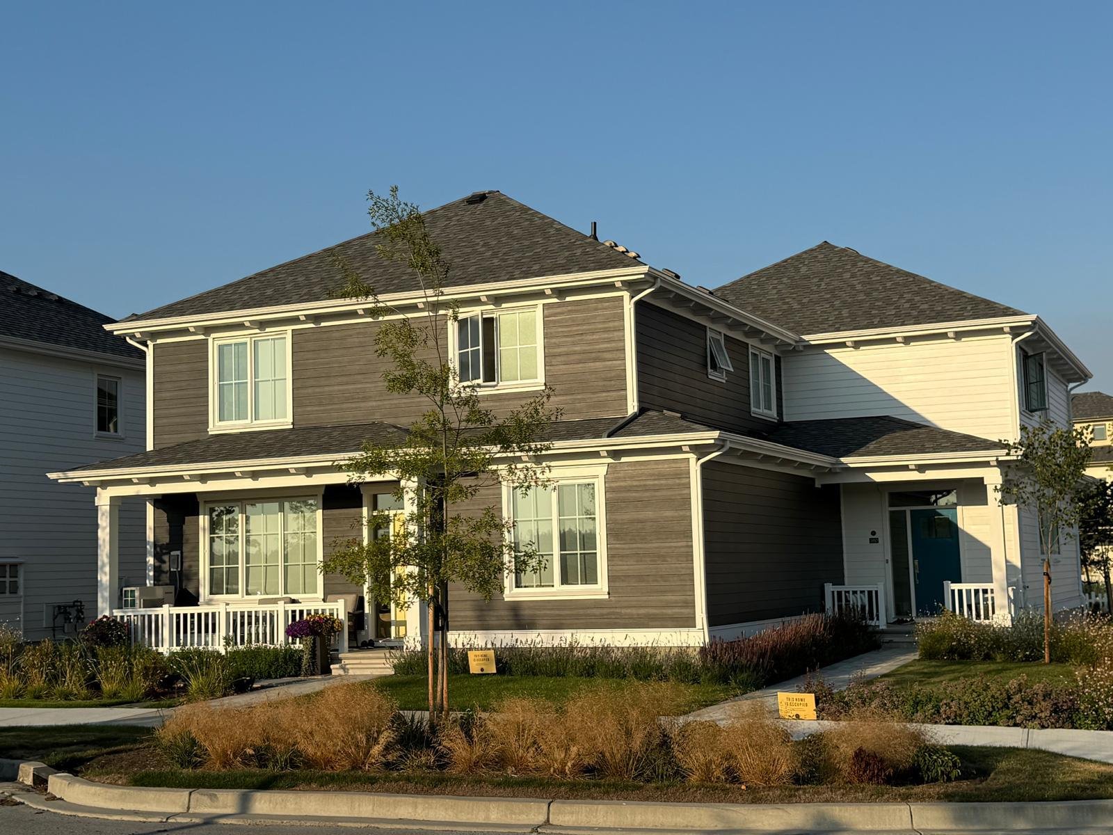 Completed two-storey home with a dark grey and white exterior