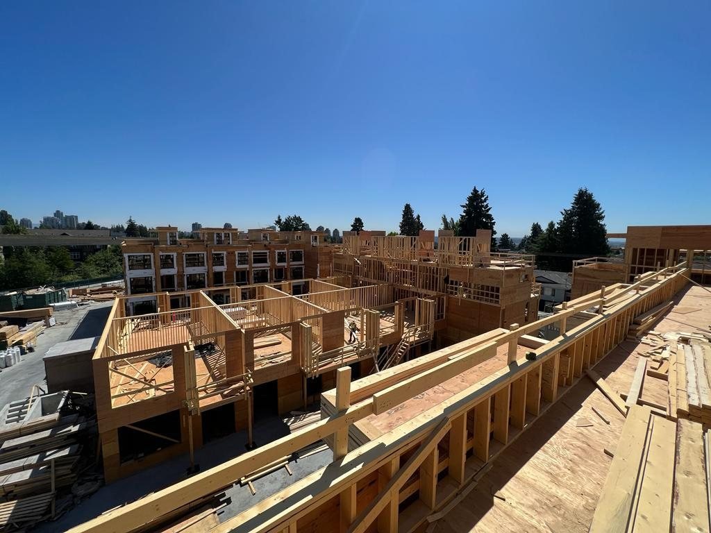Close view of timber framing and sheathing along an elevated building edge.