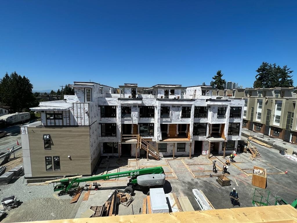 High-angle view of multi-family wood framing, sheathing and site materials.