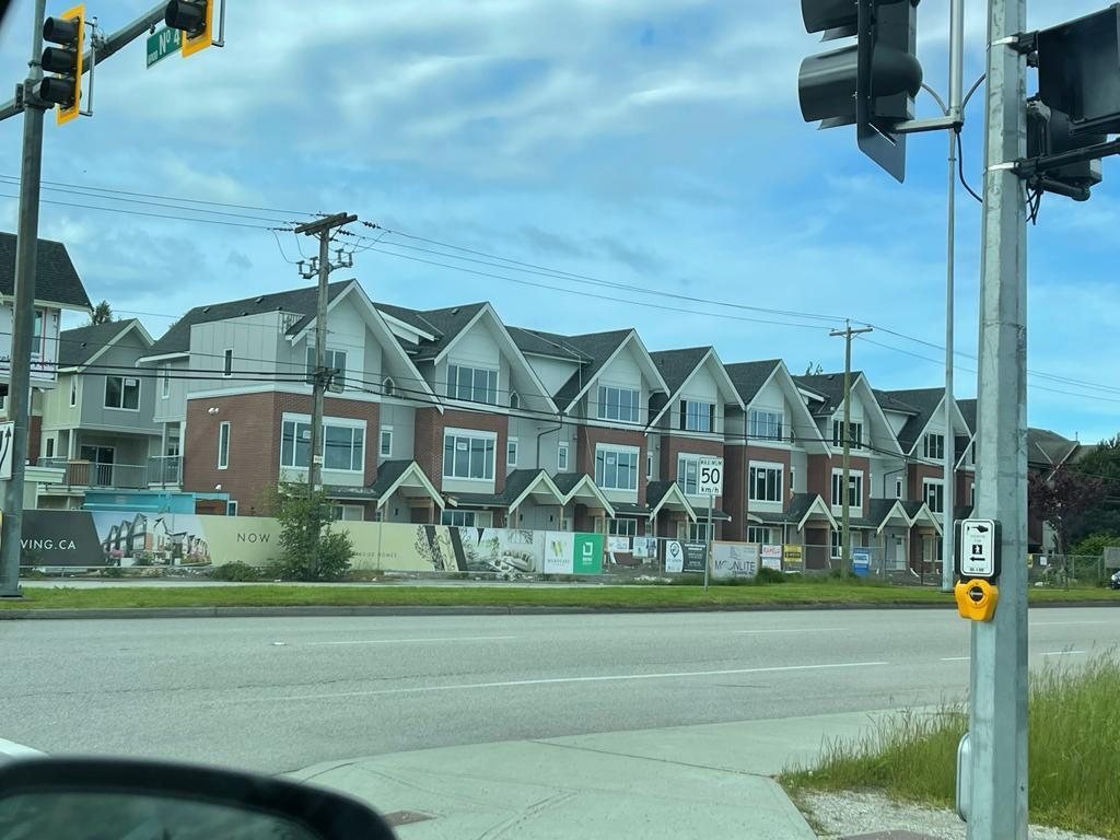 Completed row of attached multi-storey homes viewed from across the road.