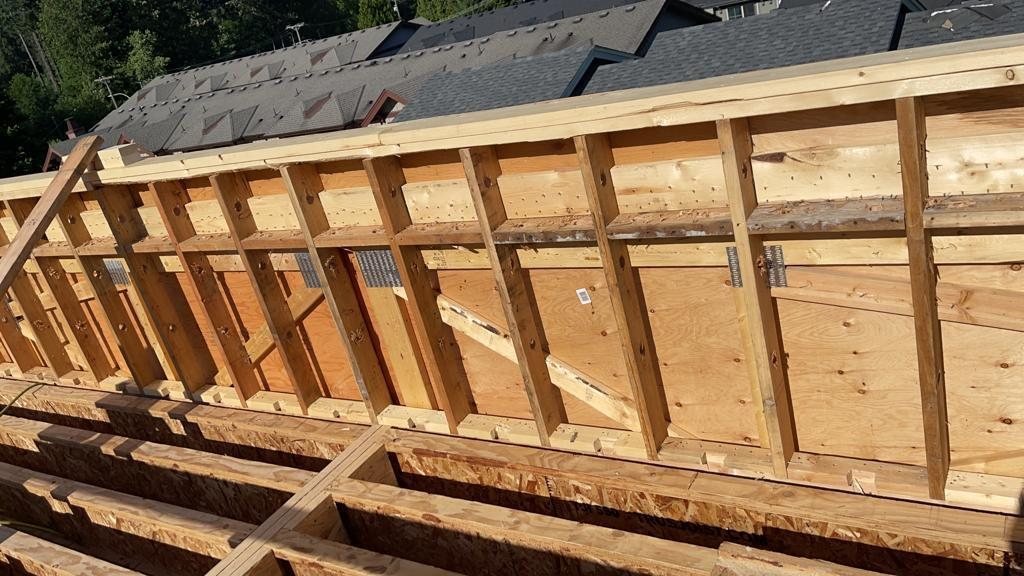 Close view of wood wall studs and structural sheathing during construction.