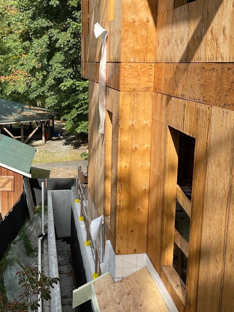 Close view of structural wall sheathing and an exposed floor edge.