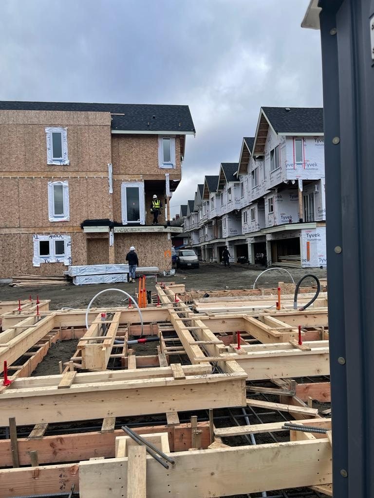 Wood floor joists and beams laid across a residential building footprint.