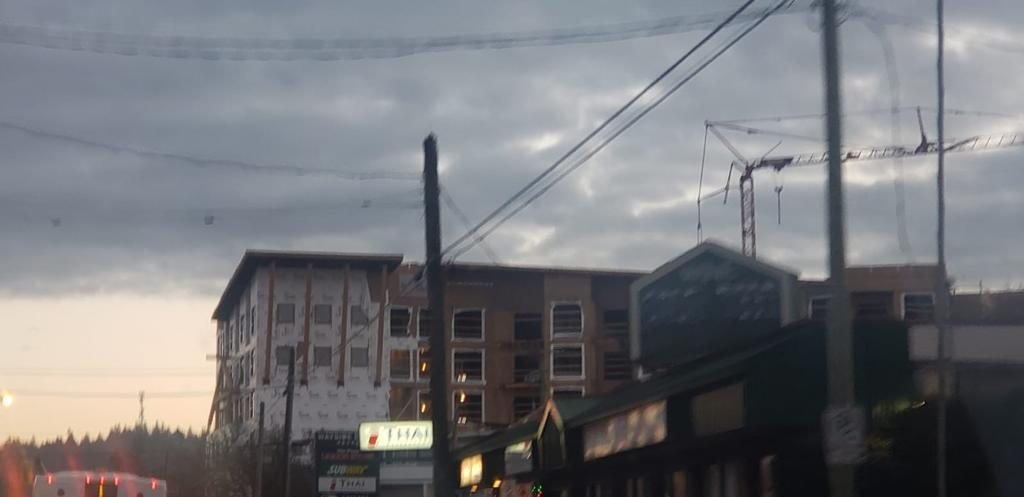 Residential building under construction viewed from across a local street.