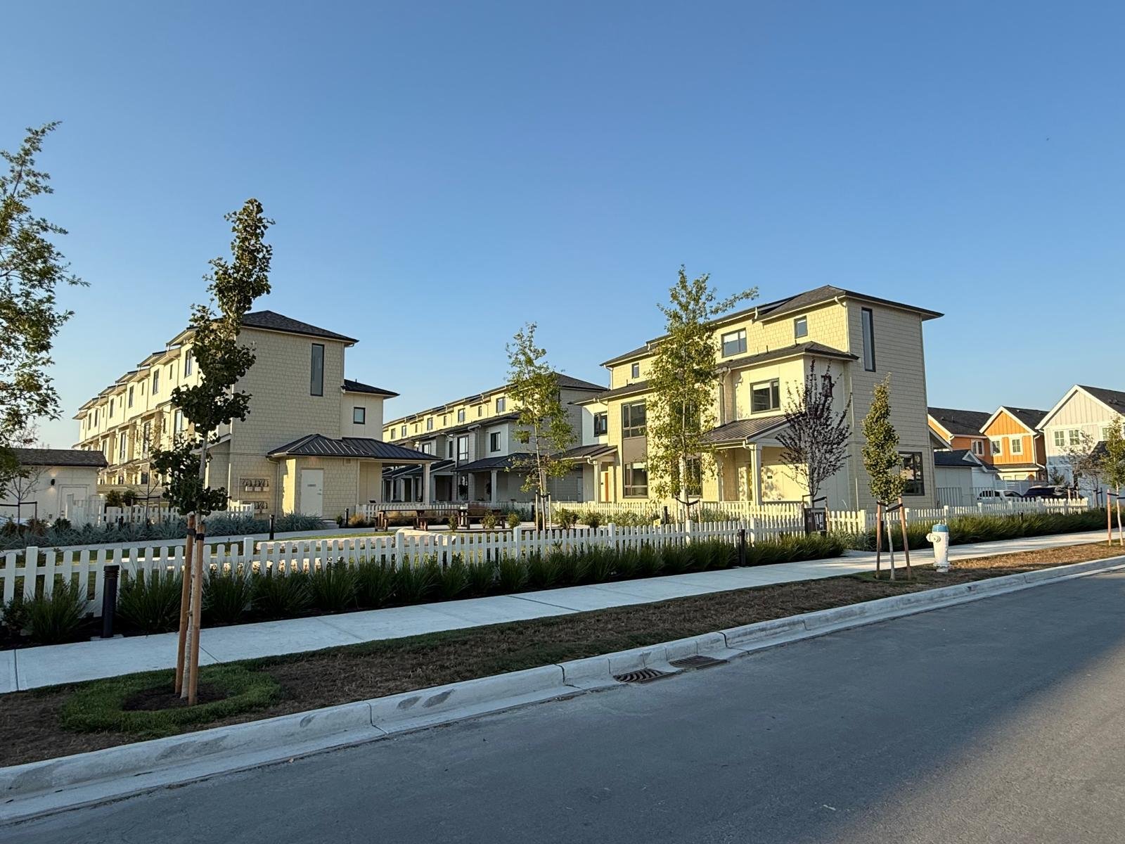 Row of completed homes with blue and white exteriors